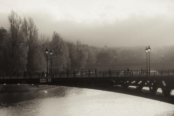 Sepia toned image of a bridge over the Seine River in Paris.